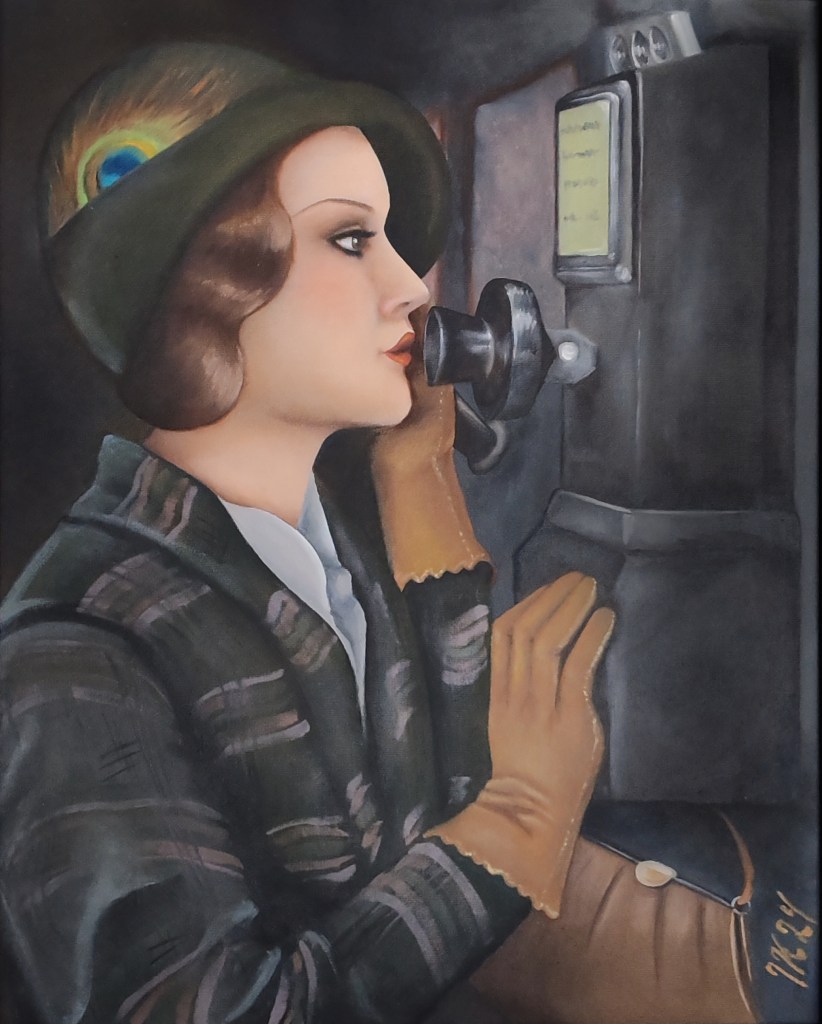 1920's or 1930's woman in green suit and hat using an old fashioned public telephone.